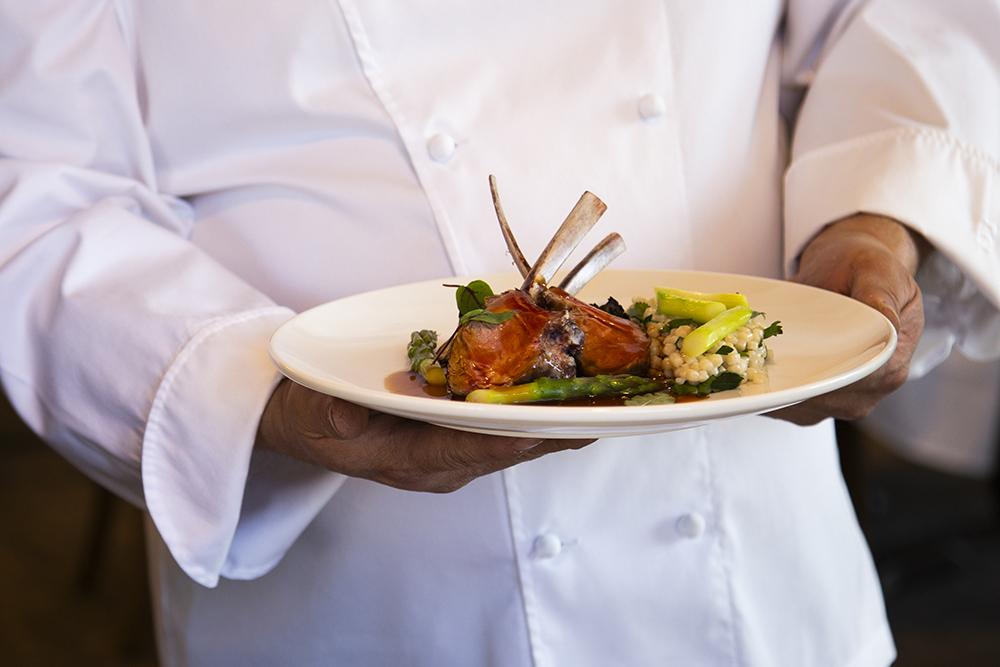 Chef holding plate of food