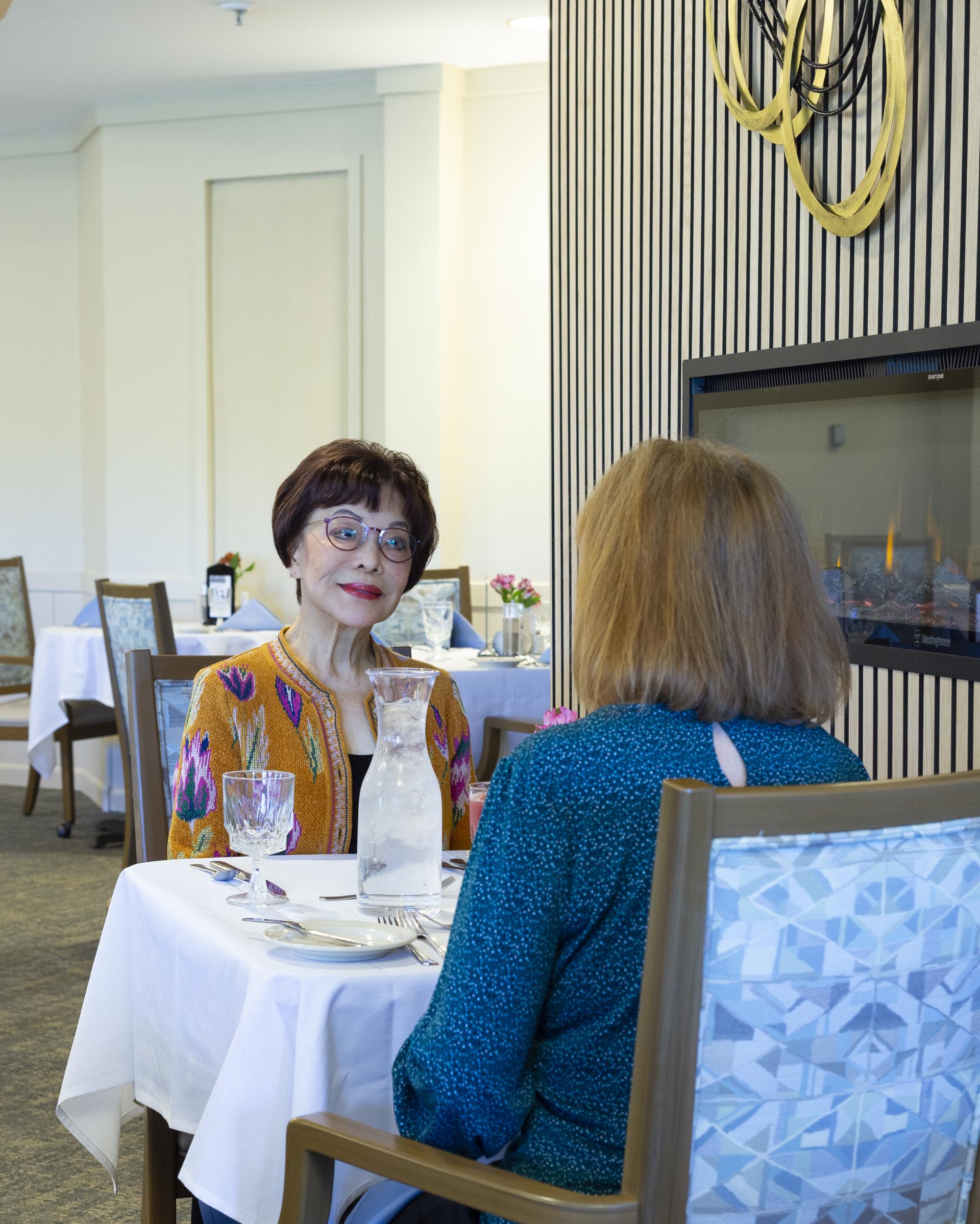 Two women seated at dinning table